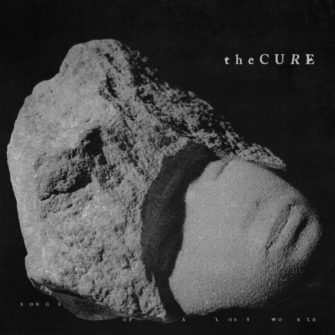 Okładka płyty The Cure Songs of a Lost World Na okładce jest kamienna rzeźba , okładka jest cała szara